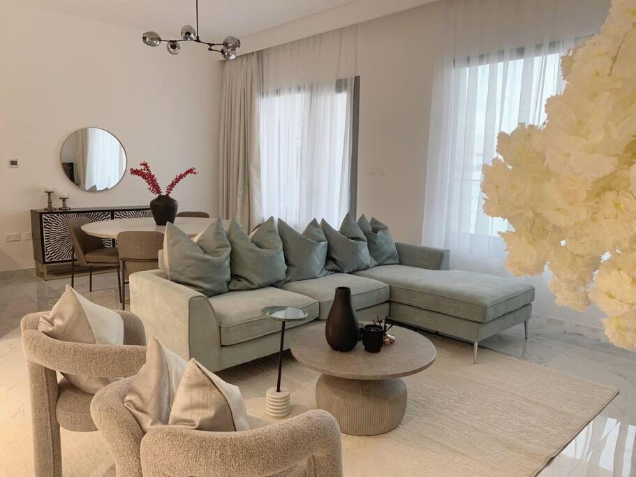 a living room with a couch and chairs and a table at Oasis in the Desert in Al Qurayyah