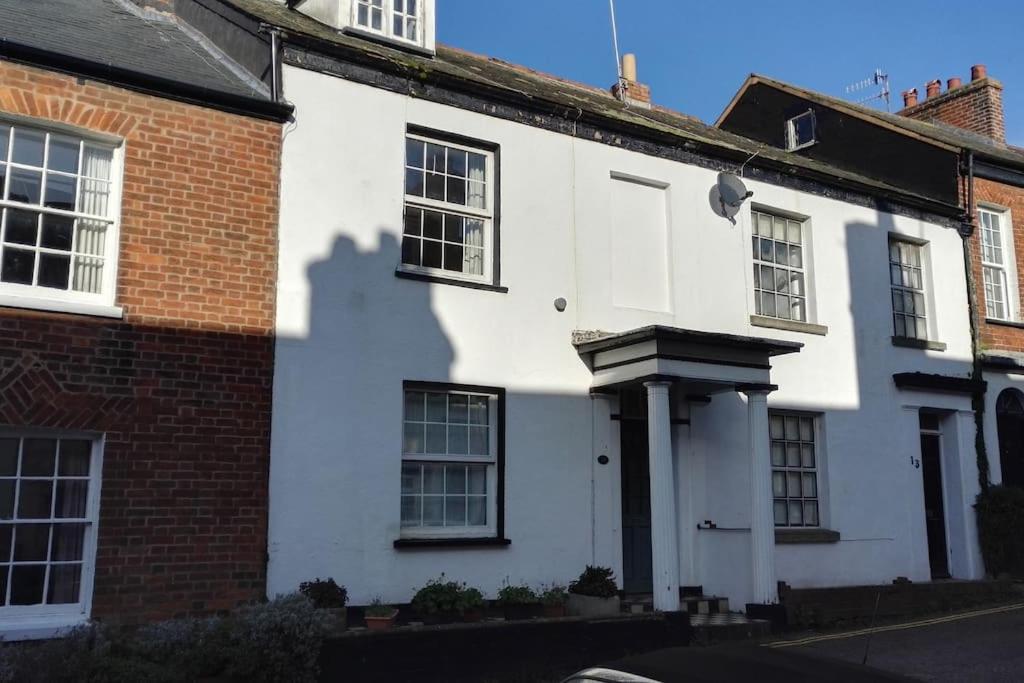 a white house with a red brick building at Seaside, Exmouth Centre - sleeps 6+ in Exmouth