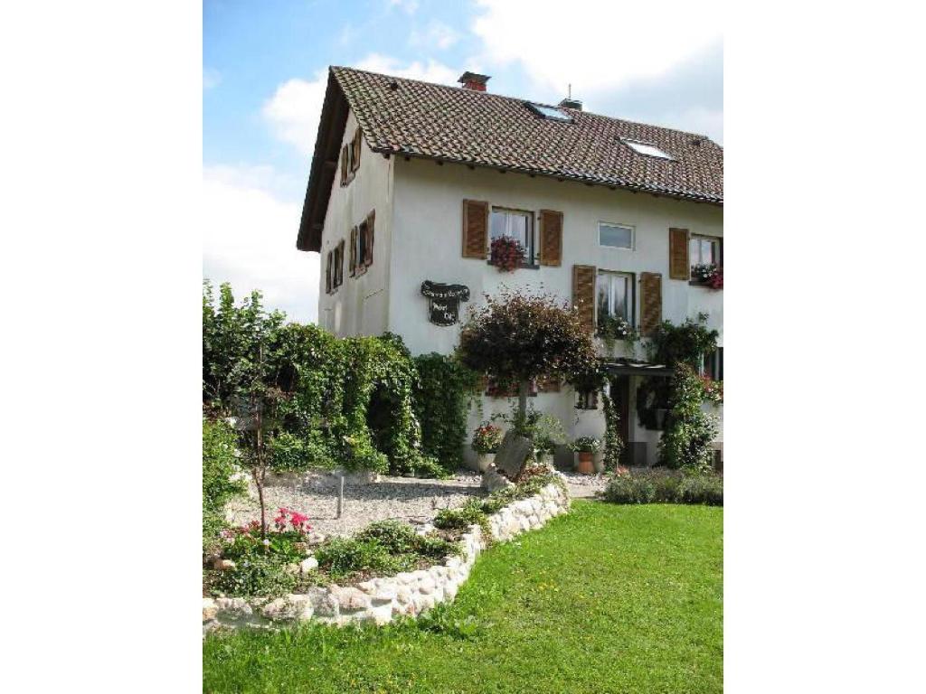 una casa blanca con un jardín delante de ella en Haus am Brunnen, en Titisee-Neustadt