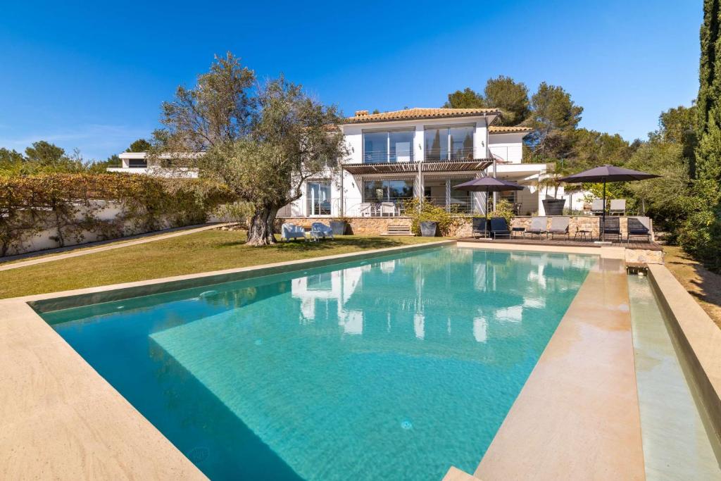 a large swimming pool in front of a house at Villa Vista in Pollença