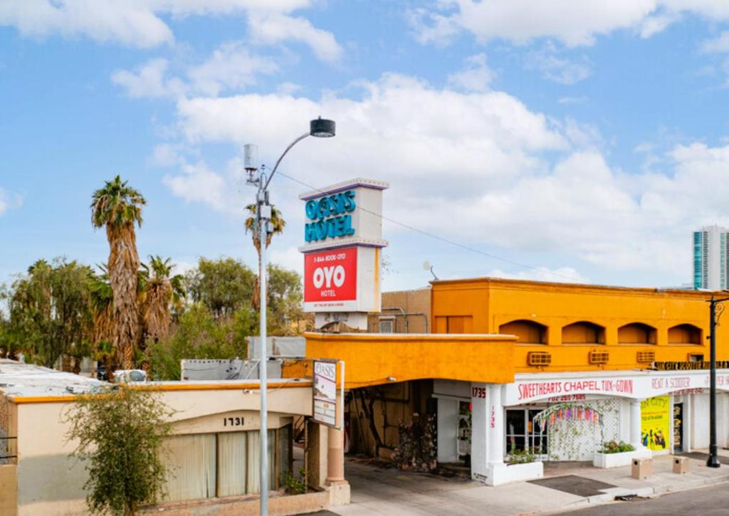 a yellow building with a stop sign on top of it at OYO Oasis Motel Las Vegas I-15 in Las Vegas