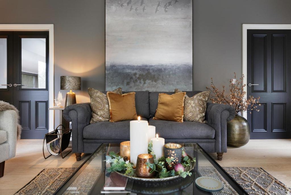 a living room with a couch and a table with candles at Luxurious Interior Designed Home in Kenmare