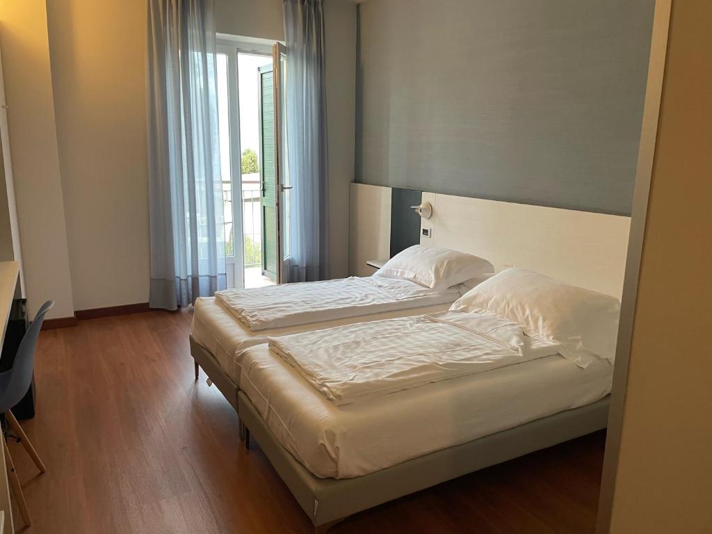 Postel nebo postele na pokoji v ubytování Hotel Al Caval