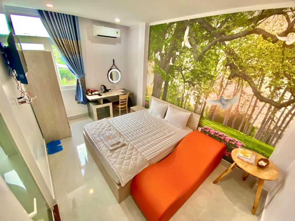 a bedroom with a bed and a large window at Hotel Phước Thịnh in Vĩnh Long