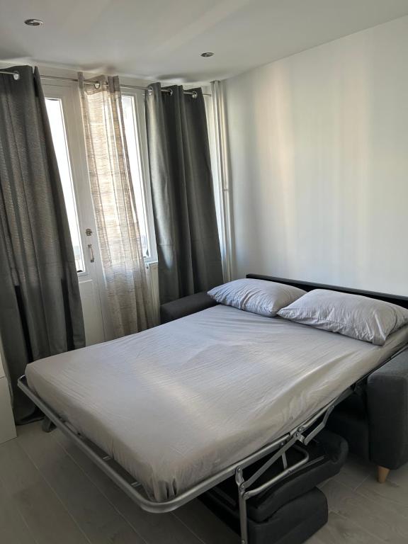Cette chambre comprend un grand lit et une fenêtre. dans l'établissement Appartement 2 pièces, à Nice