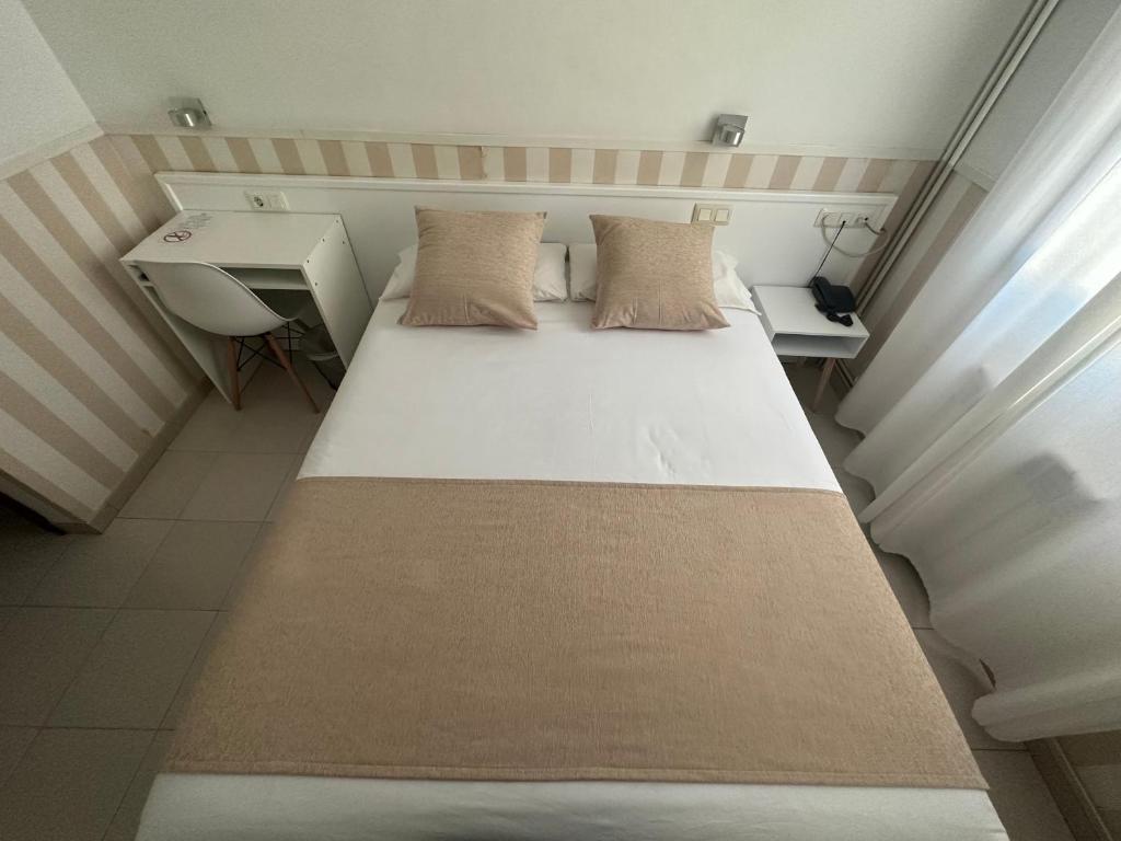 Postel nebo postele na pokoji v ubytování Hotel Torino