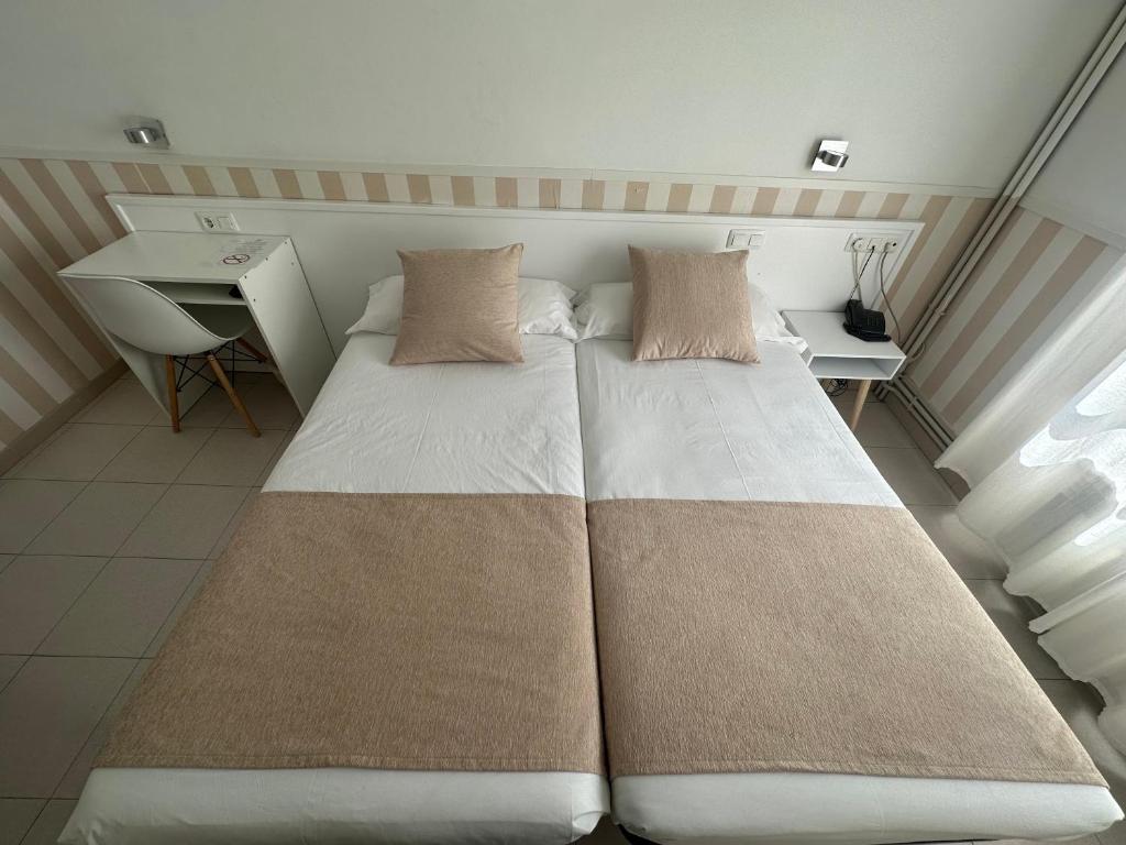 Postel nebo postele na pokoji v ubytování Hotel Torino