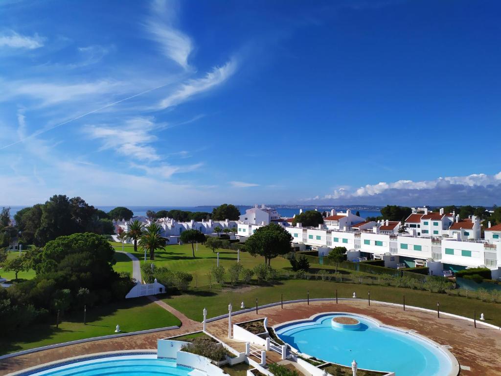 a view of a resort with two pools and houses at Prainha Clube in Alvor