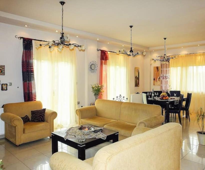 a living room with two couches and a dining room at House with Garden near the Beach in Heraklio