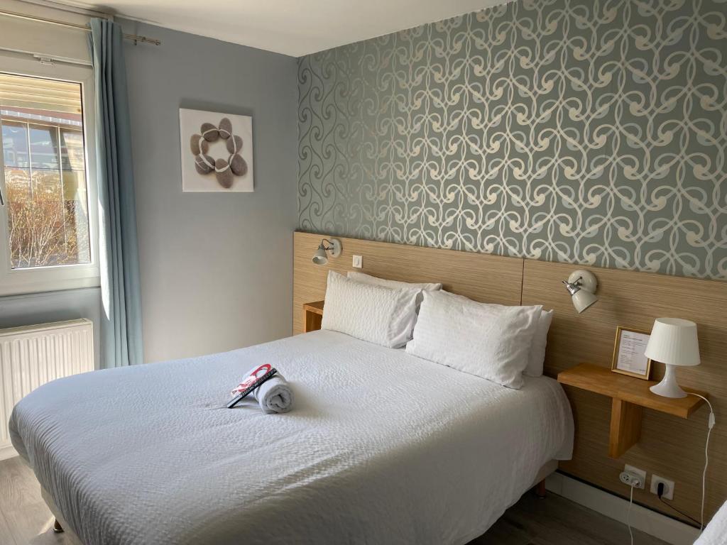 Postel nebo postele na pokoji v ubytování Hôtel Oxo