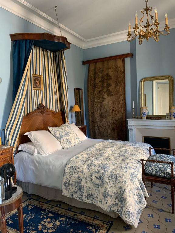 a bedroom with a bed and a fireplace at La Maison du Magistrat in Durban-Corbières