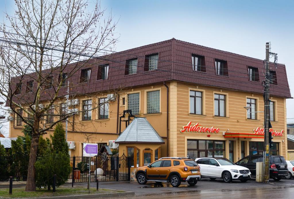 um carro laranja estacionado em frente a um edifício em Little Orient em Braila