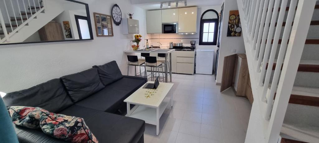a living room with a couch and a table at HATO Holiday Home Fuerteventura in Costa Calma