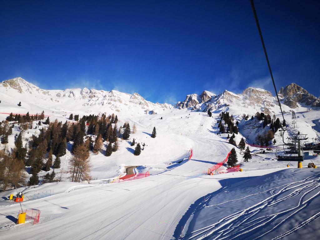 a snow covered mountain with a ski lift at Villa Vittorio in Forno di Zoldo