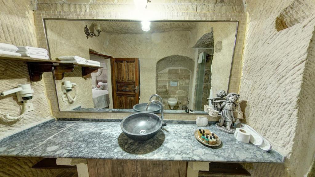 a bathroom with a sink and a mirror at Roc Of Cappadocia in Göreme