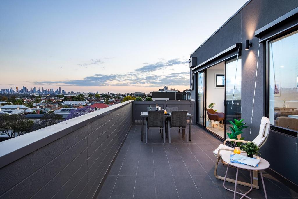 an apartment balcony with a view of the city at Queensview168 Apartments Moonee Ponds in Melbourne