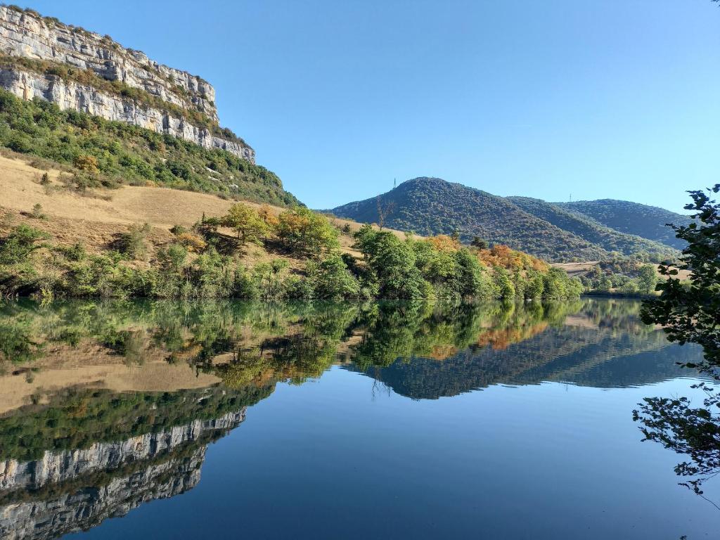 a view of a river with mountains in the background at La Vie du Bief in Bolozon