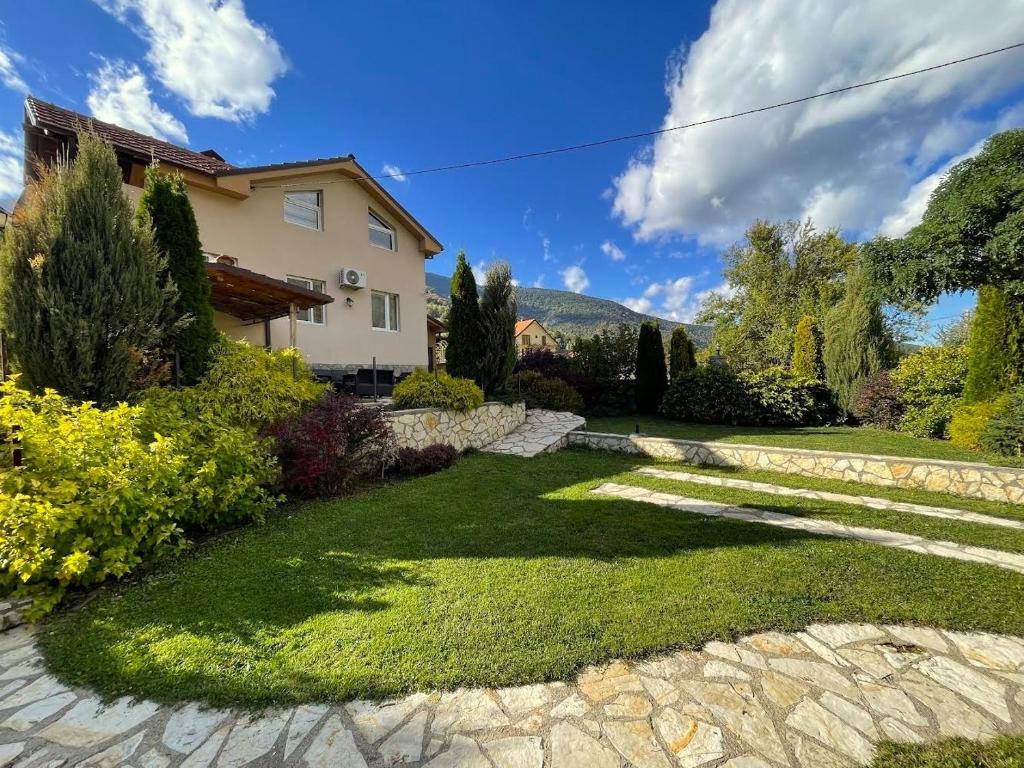 a house with a stone walkway in a yard at Villa Maria in Nižepole