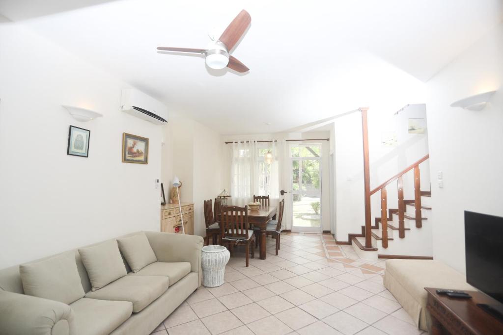 a living room with a couch and a table at Nirachel Ltd in Belle Mare