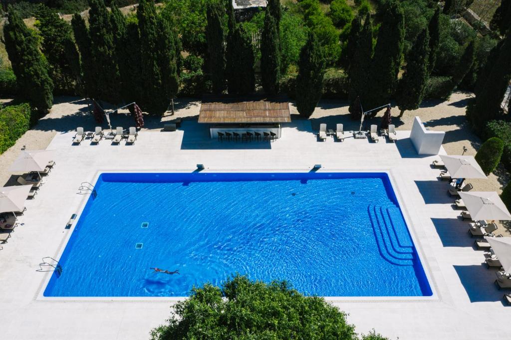 an overhead view of a swimming pool with chairs and trees at Son Julia Country House & Spa in Llucmajor