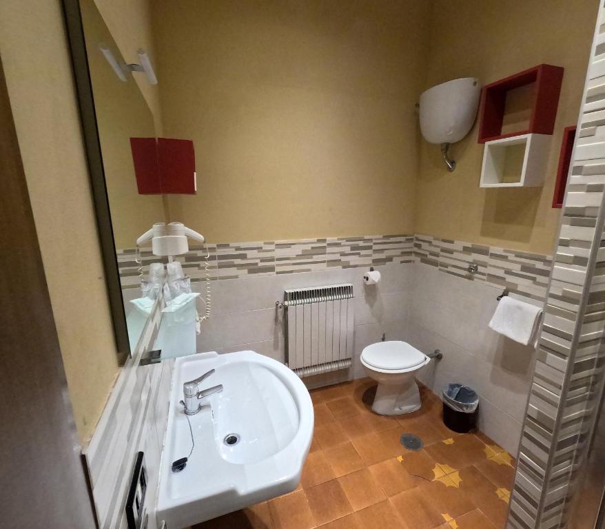 a bathroom with a sink and a toilet at Roma Room Hotel in Rome