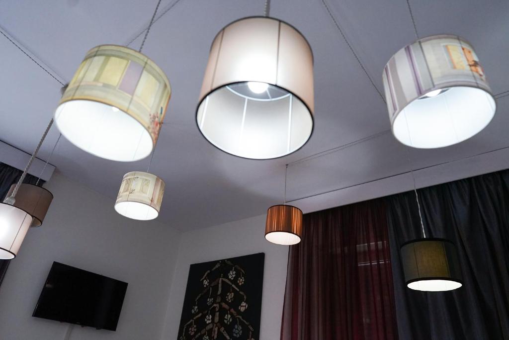 a group of lights hanging from the ceiling at Roma Room Hotel in Rome