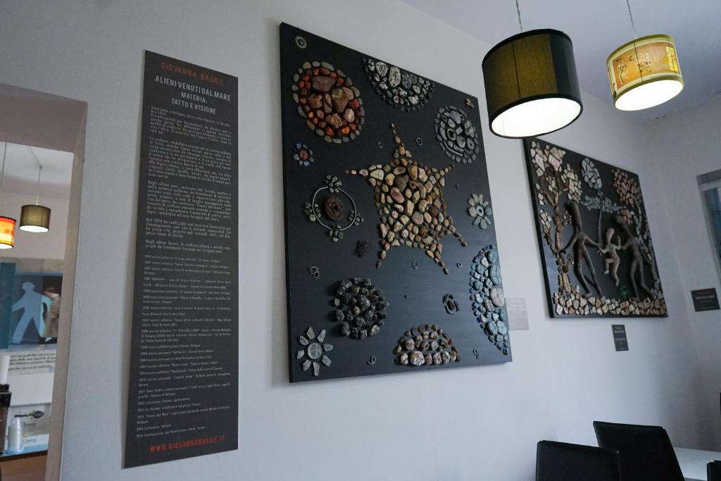 two posters on the wall of a restaurant at Roma Room Hotel in Rome