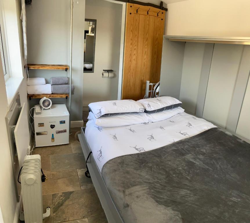a small bedroom with two beds in it at Adorable bedsit for you, partner and your pet! in Pembrokeshire