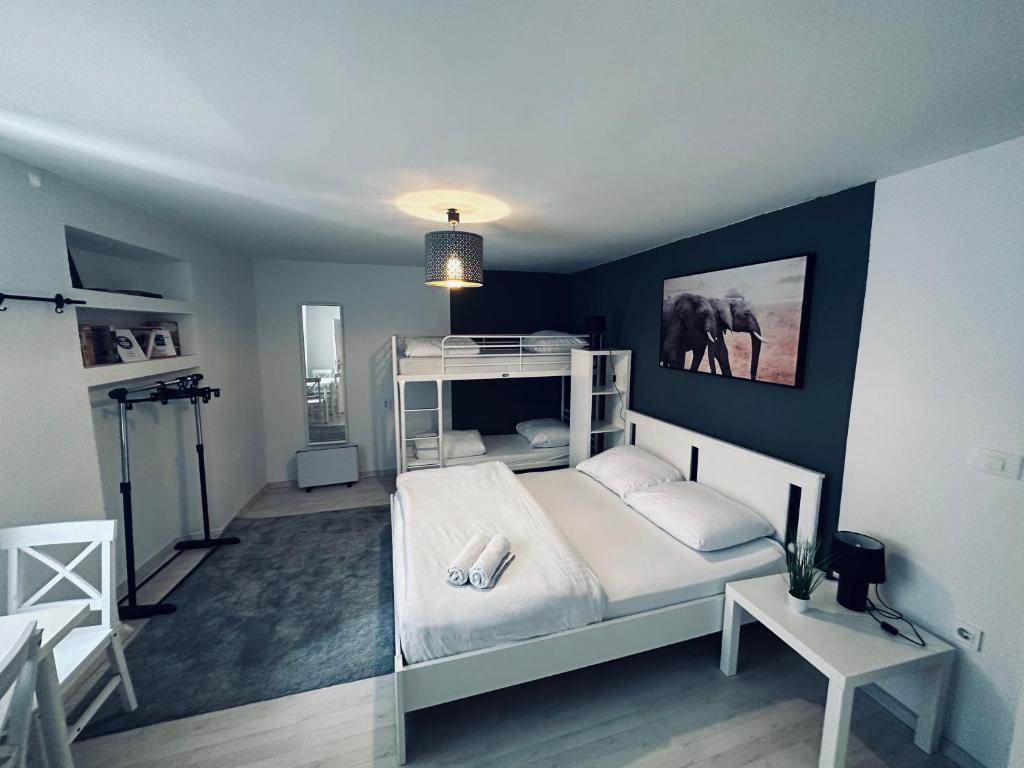 a bedroom with a white bed and an elephant on the wall at Hostel Sleeping Beauty in Ljubljana