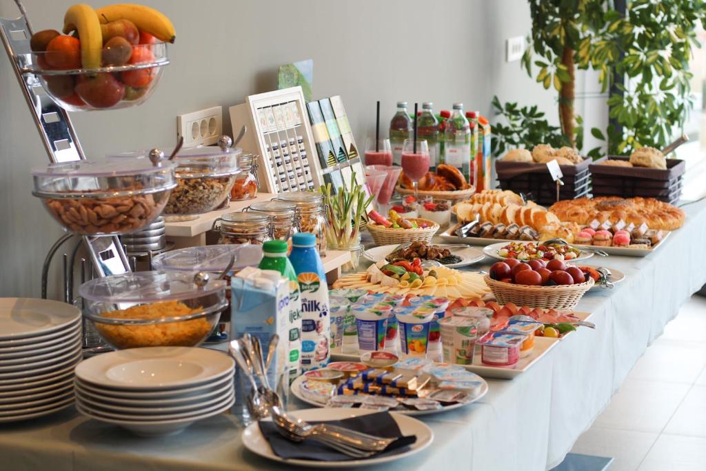 a buffet of food on a table with plates at Pansion Leggero in Krk