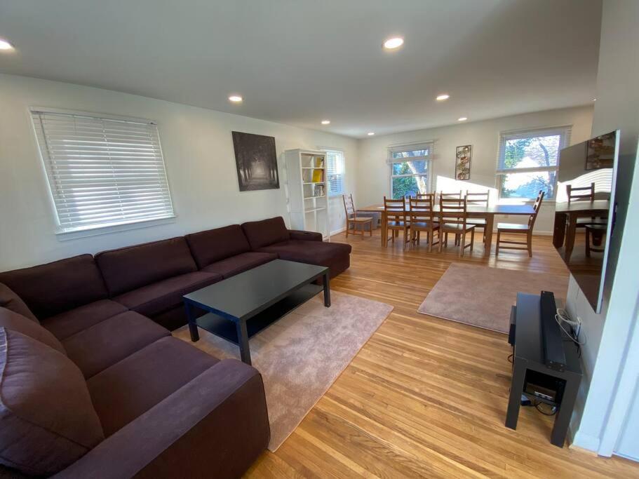 a living room with a brown couch and a table at Park B&B in Oxon Hill