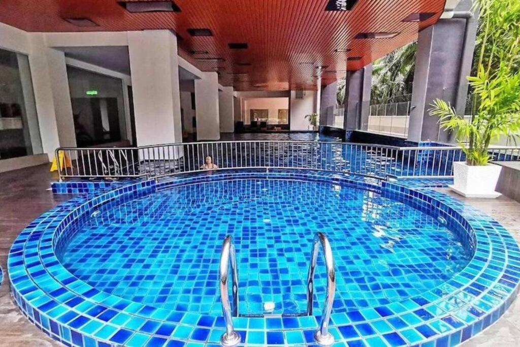 a large swimming pool with blue tiles in a building at 92D’venus Residence in Sitiawan