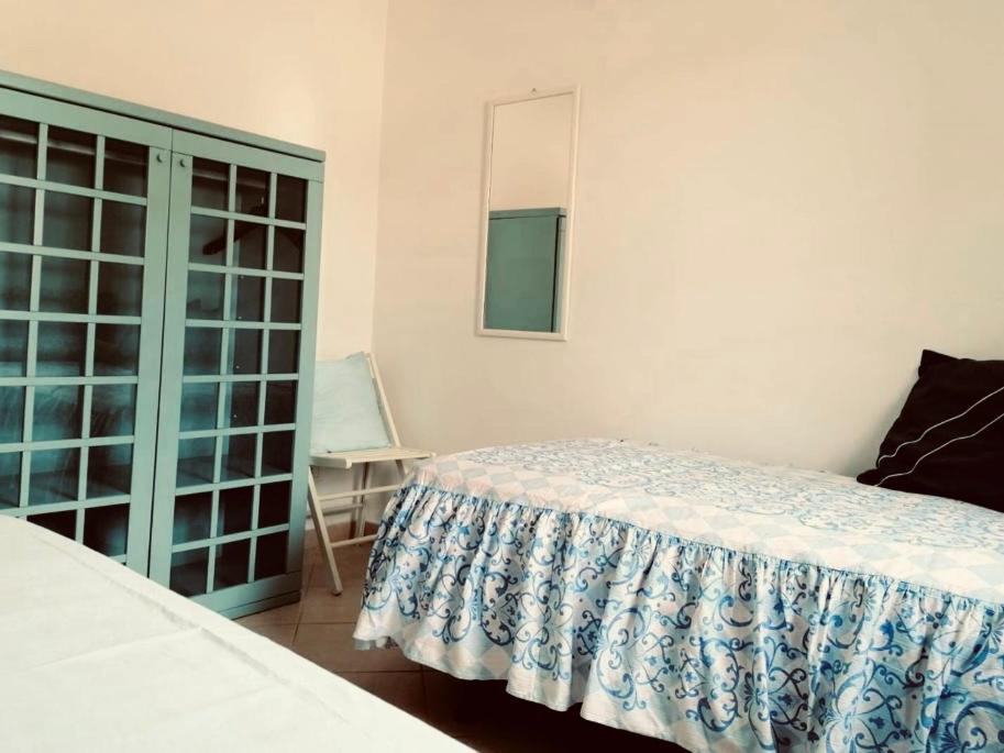 a bedroom with a bed and a mirror and a chair at La Racioppola in Ostuni