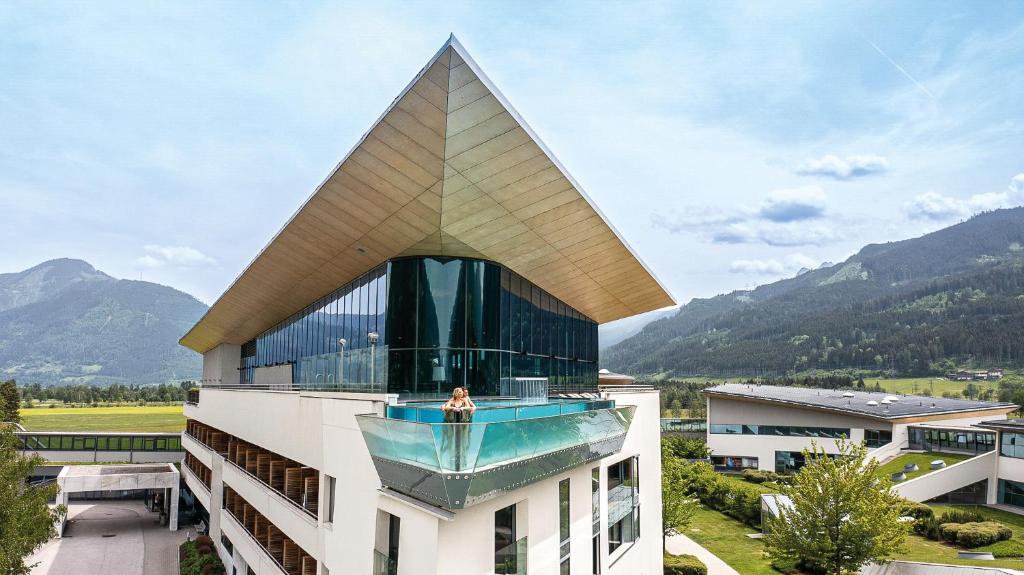 a person sitting on top of a building at Tauern Spa Hotel & Therme in Kaprun