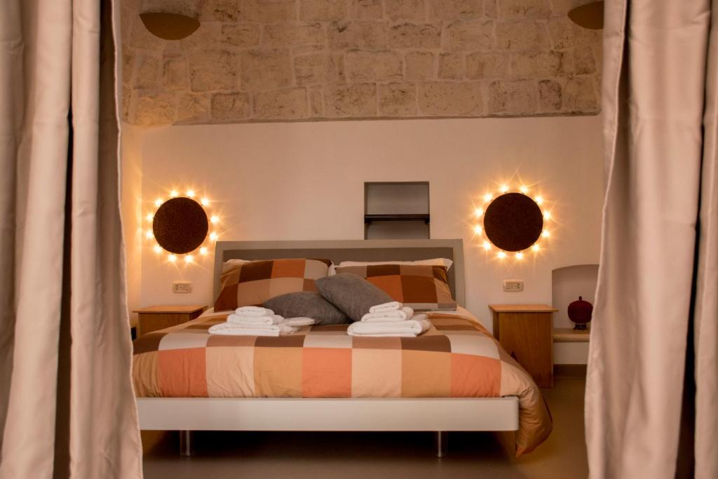 Postel nebo postele na pokoji v ubytování Pavì Trulli e Suites