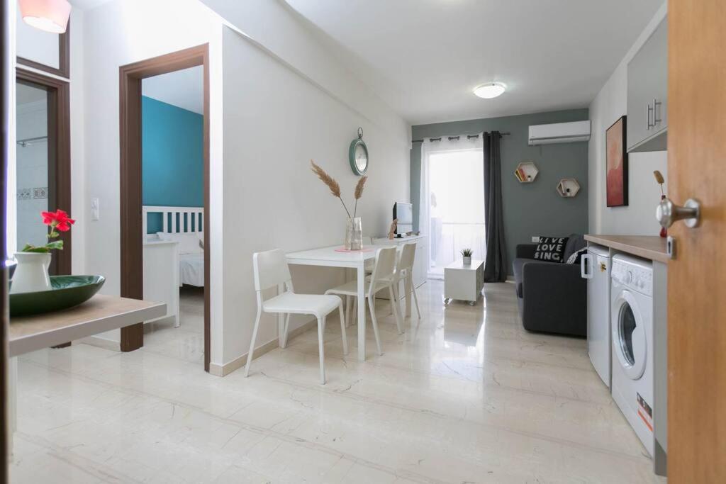 a kitchen and living room with a table and chairs at In the heart of the city in Heraklio