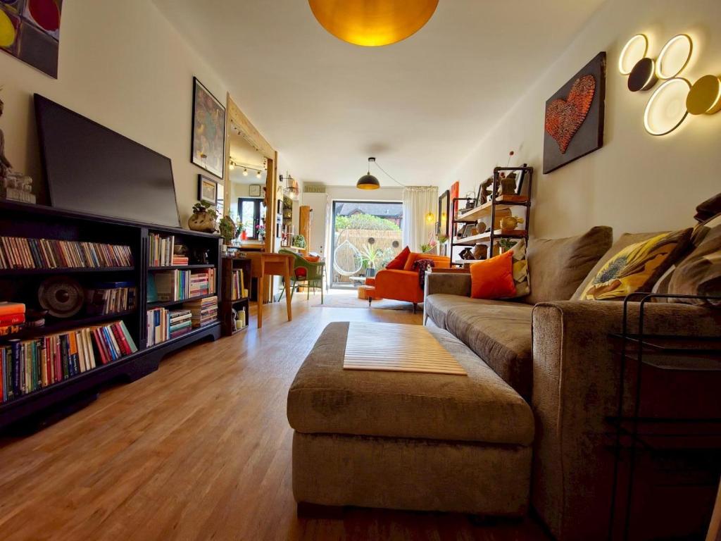 a living room with a couch and bookshelves at Pass the Keys Oasis Escape Central Gorgeous in Poole