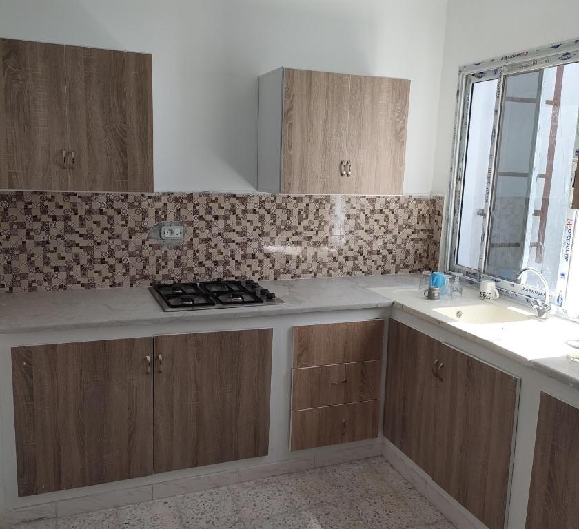 a kitchen with a counter top and a sink at Tiba soliman plage in Nabeul