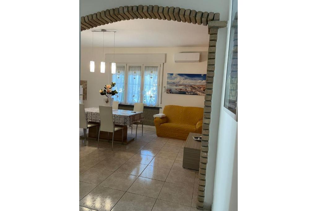 a living room with a yellow couch and a table at Pierluigi's House in Cagliari