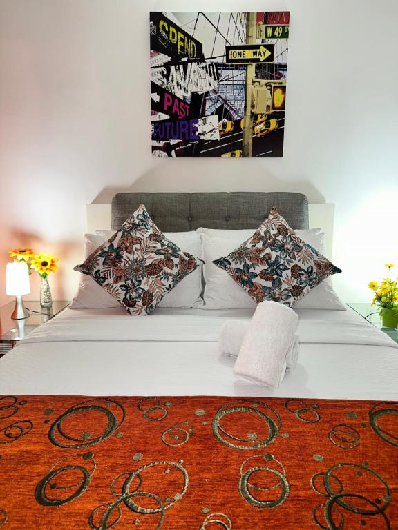 1 dormitorio con cama blanca con almohadas y alfombra en SGH hotel Mathilu Rodadero, en Santa Marta