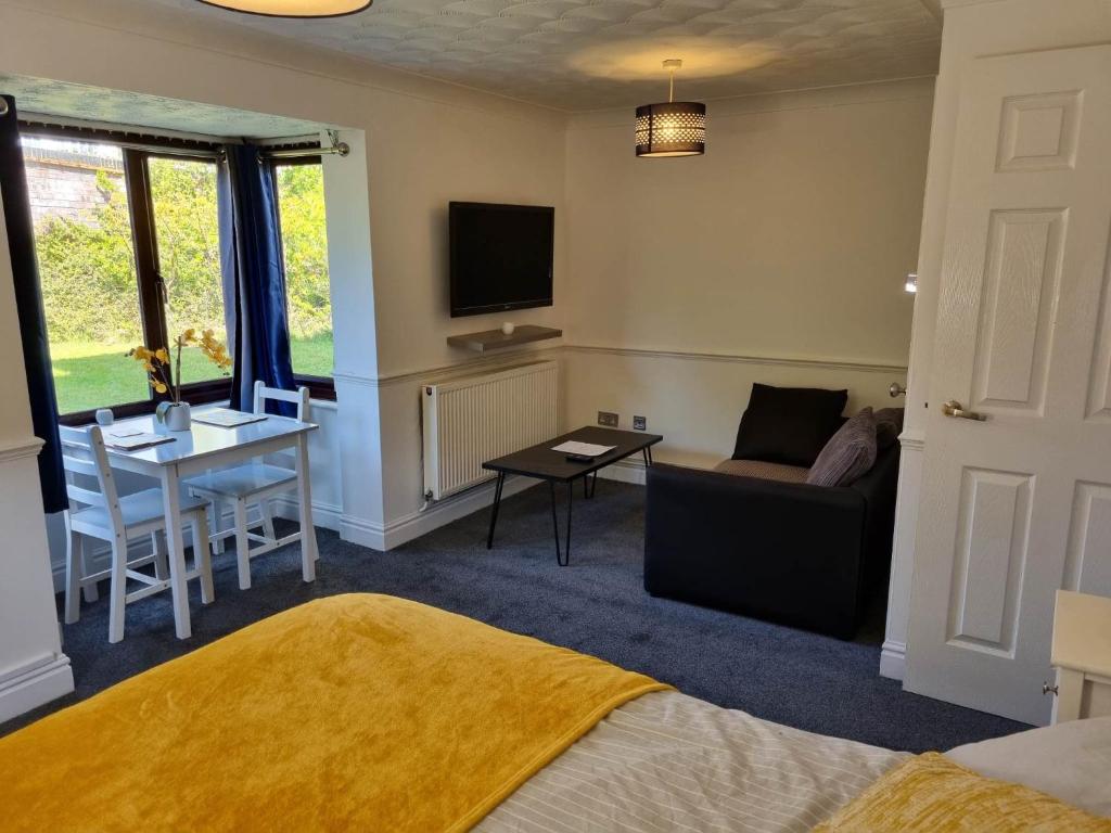 a living room with a couch and a table at Lovely City Studio near Station. Off Road Parking. in Norwich