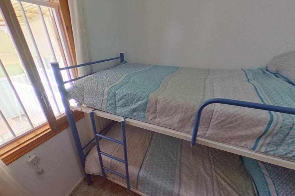 Cama o camas de una habitación en Bungalow Catral 20 en Santa Pola