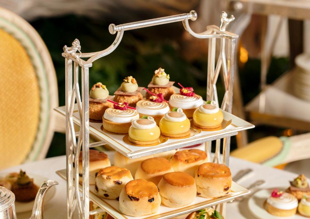 a display of pastries and donuts on a table at The Ritz London in London