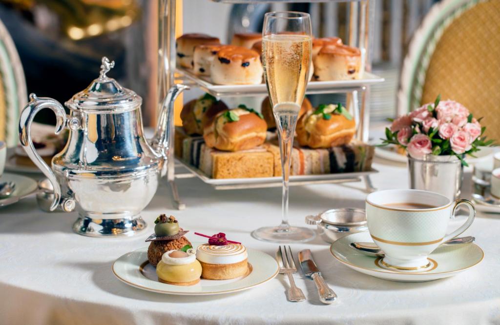 a table with plates of pastries and a cup of coffee at The Ritz London in London