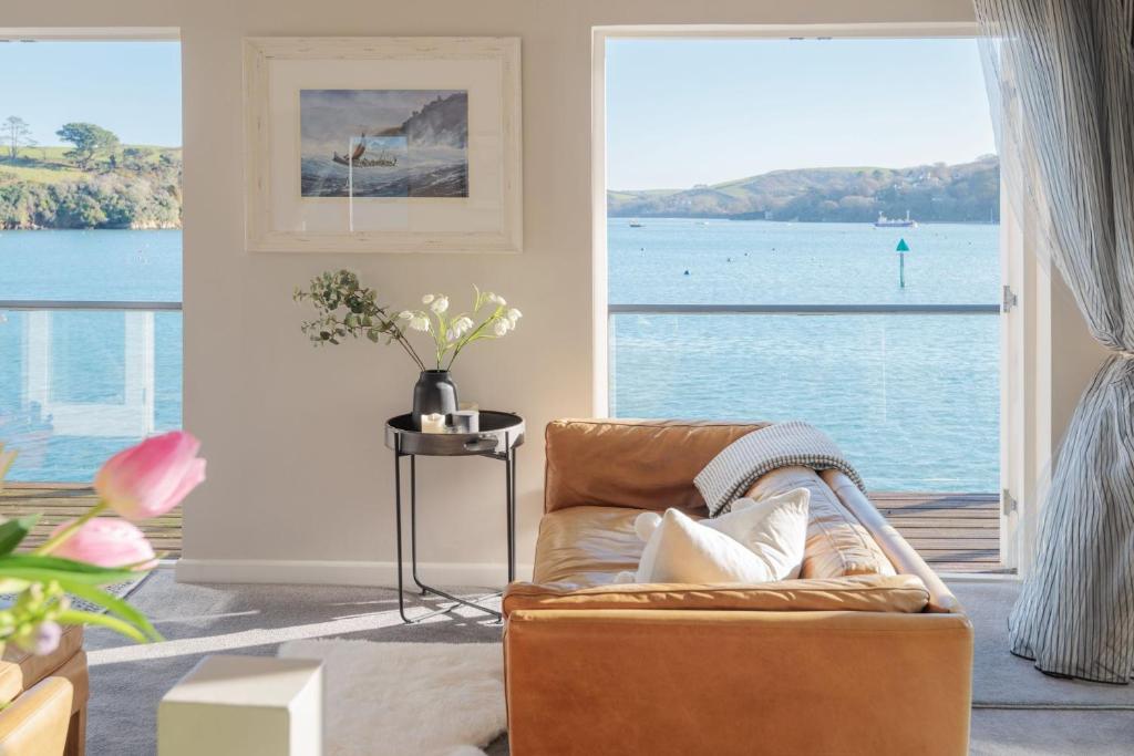 a living room with a couch and a view of the water at 2 Clifton Place in Salcombe