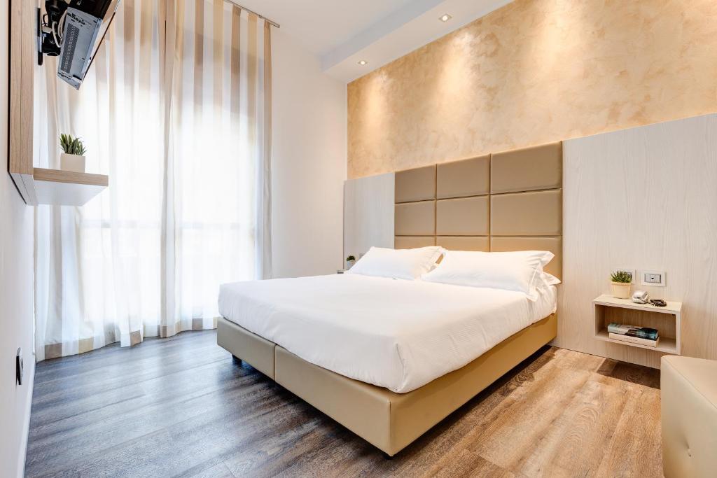 Postel nebo postele na pokoji v ubytování Hotel Piccadilly