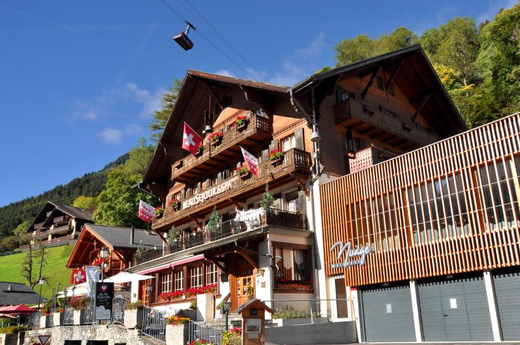 a large building with balconies on the side of it at Boutique Hotel Beau-Séjour & Spa Superior in Champéry