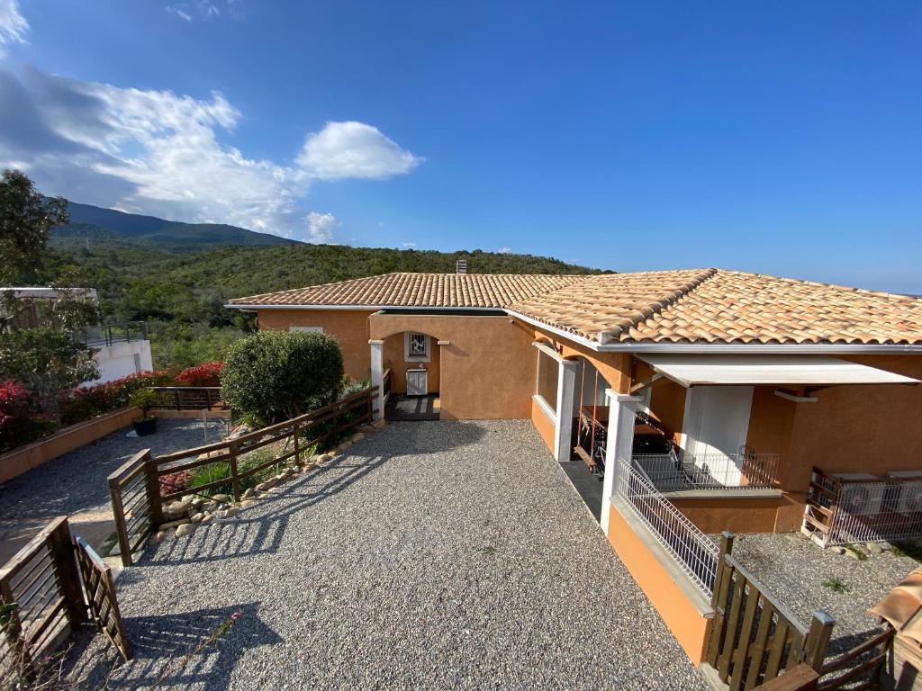 a house with a pathway leading to the front door at Boost Your Immo Corse Solenzara Tozza Alta 818 in Le Pont du Travo