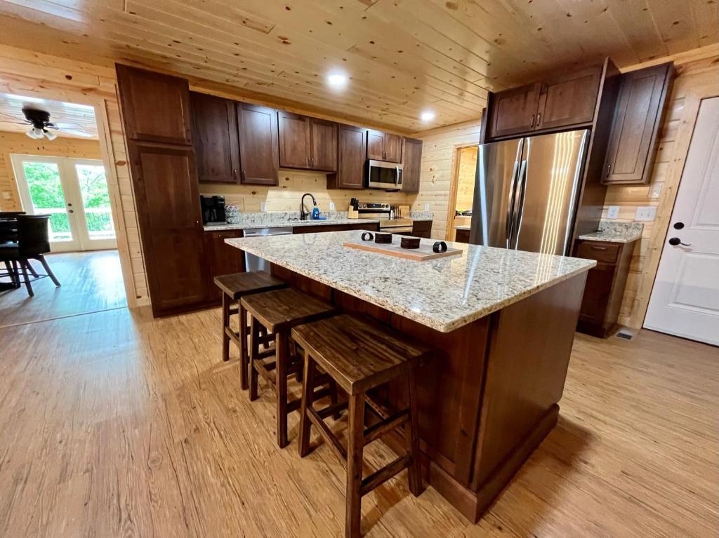 a kitchen with a large island with wooden cabinets at The Hitching Post: Spacious 5BR/4BA Rancher in Pigeon Forge
