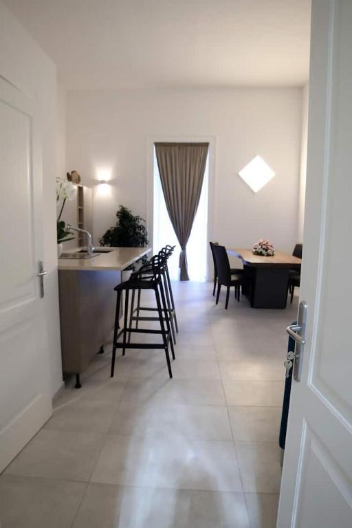 a kitchen and a living room with a table and chairs at NANNI LOFT HOUSE in Castellammare di Stabia